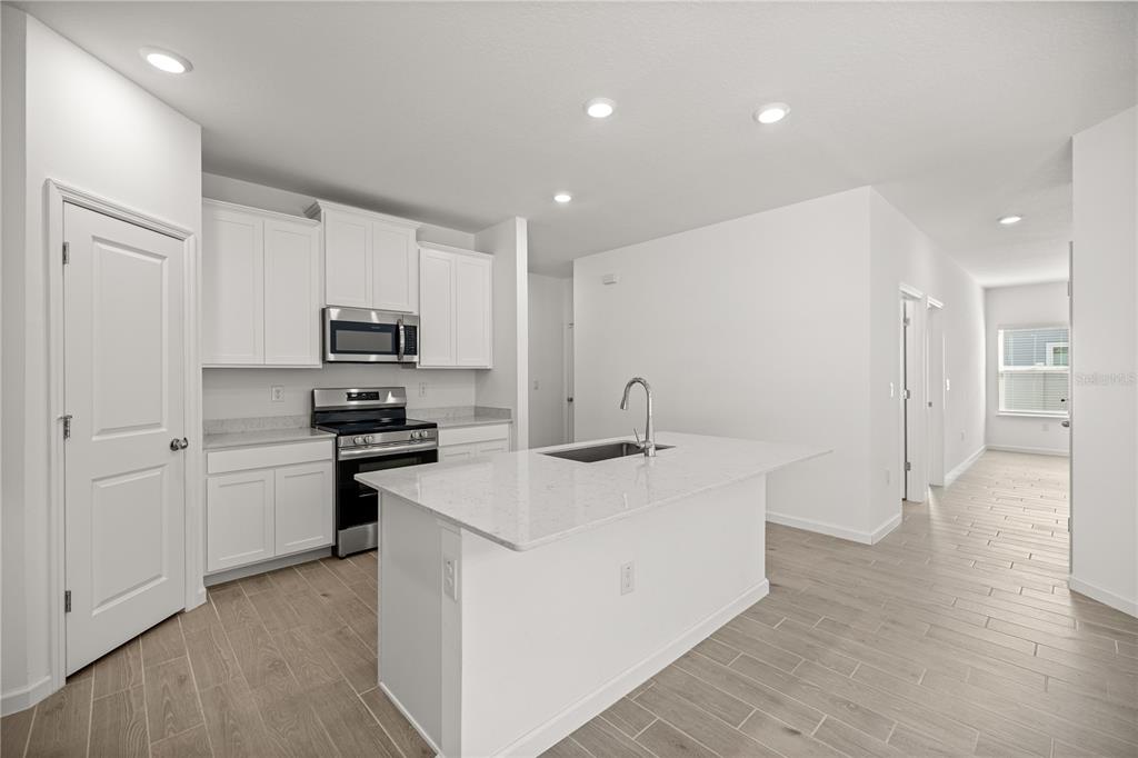 1604 Northwest 44th Court Road Ocala, FL 34482 - Photo 17 of 41 a kitchen with stainless steel appliances a sink stove refrigerator and cabinets