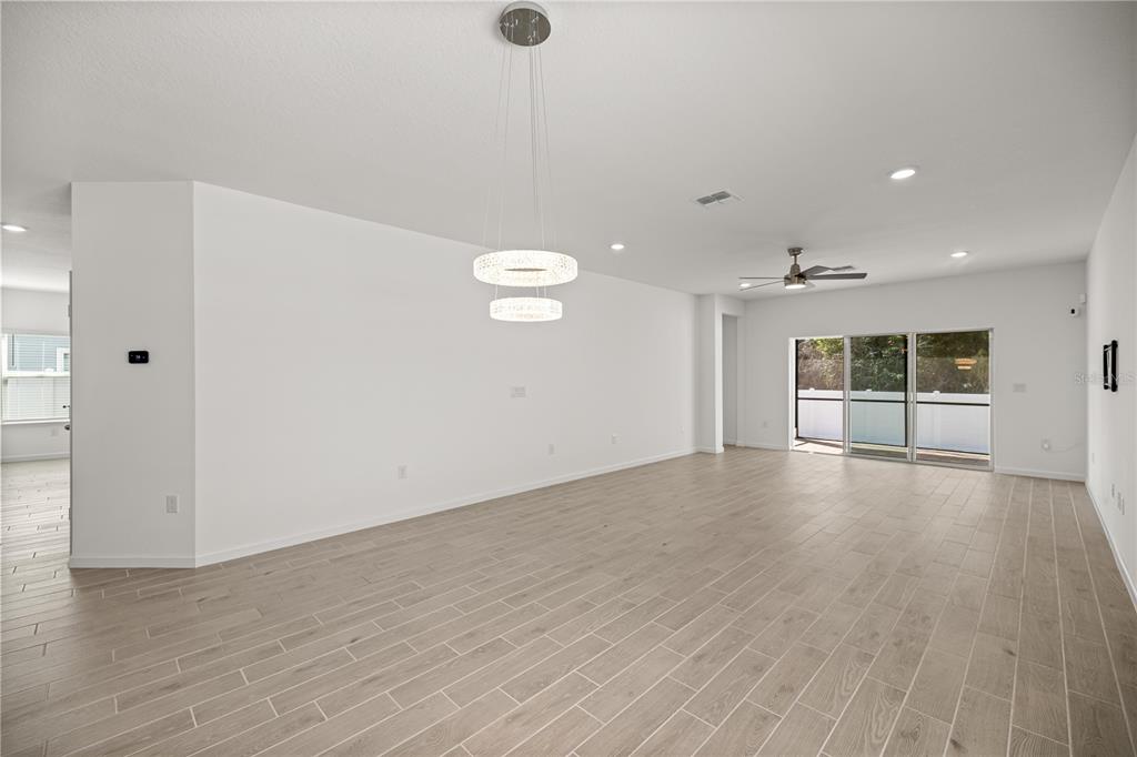1604 Northwest 44th Court Road Ocala, FL 34482 - Photo 18 of 41 a view of an empty room with wooden floor and a window