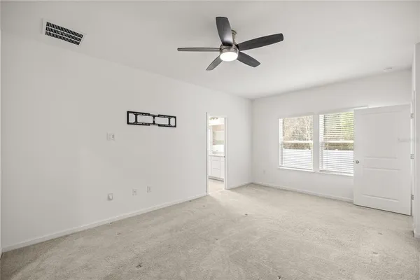 a bathroom with a granite countertop sink mirror and a bathtub