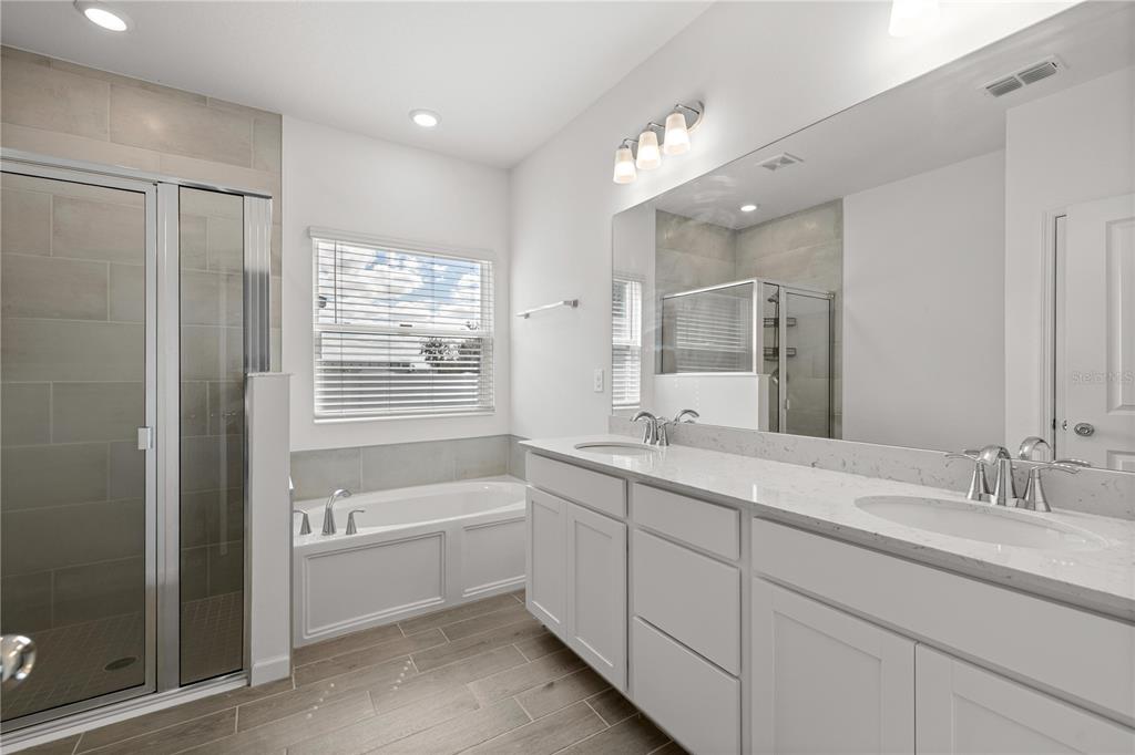 1604 Northwest 44th Court Road Ocala, FL 34482 - Photo 26 of 41 a bathroom with a granite countertop sink mirror and a bathtub