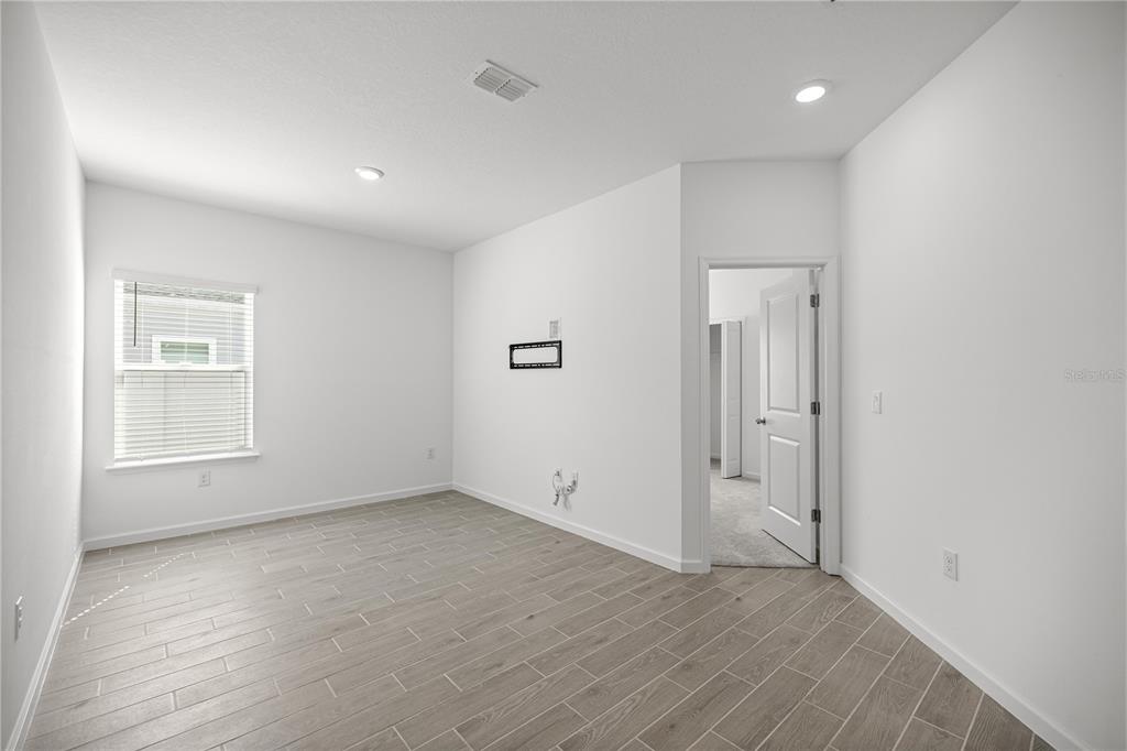 1604 Northwest 44th Court Road Ocala, FL 34482 - Photo 29 of 41 an empty room with wooden floor and windows