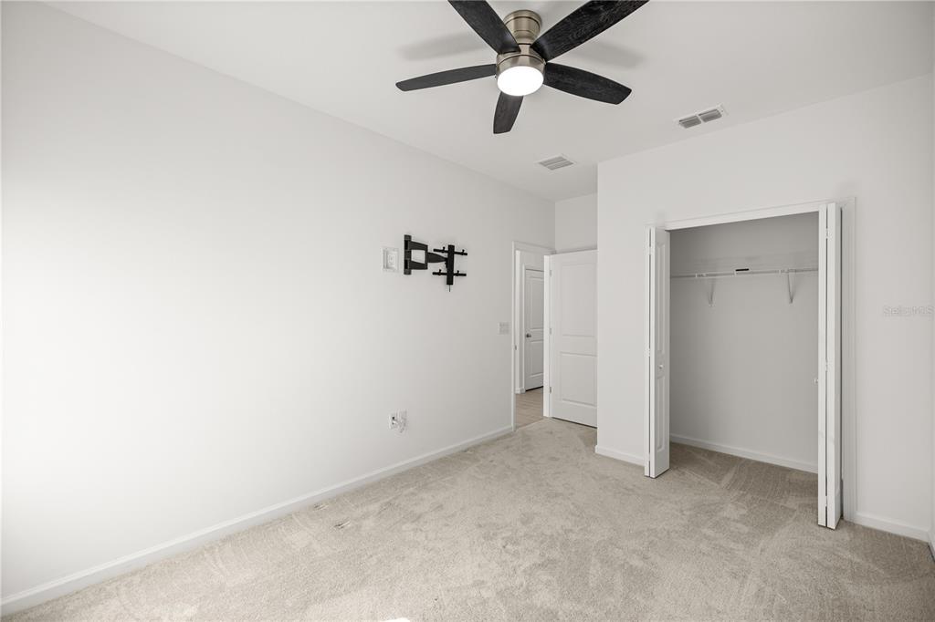 1604 Northwest 44th Court Road Ocala, FL 34482 - Photo 35 of 41 an empty room with closet and a chandelier fan