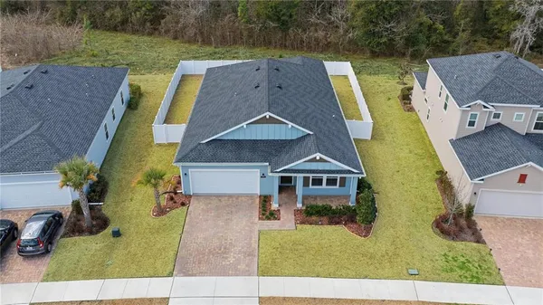 an aerial view of a house with a big yard