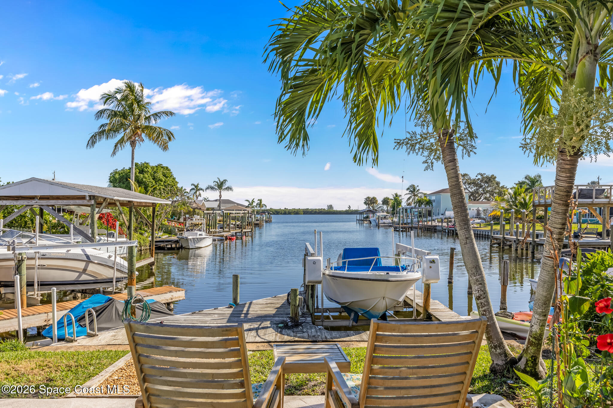 770 New Hampton Way Merritt Island, FL 32953 - Photo 1 of 48 a view of a lake with a table and chairs