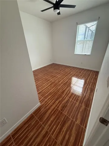 a view of a room with wooden floor and staircase
