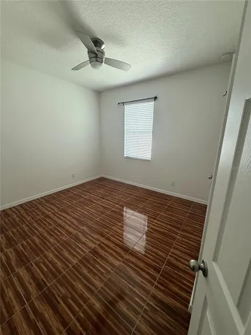 a view of a room with wooden floor