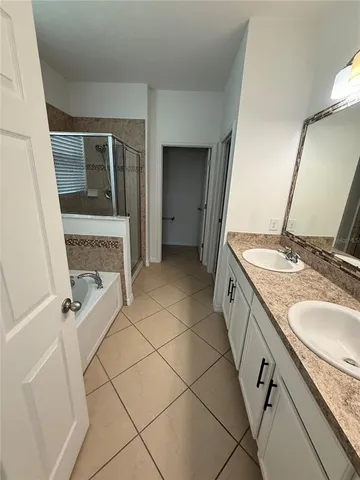 a spacious bathroom with a granite countertop sink and a mirror