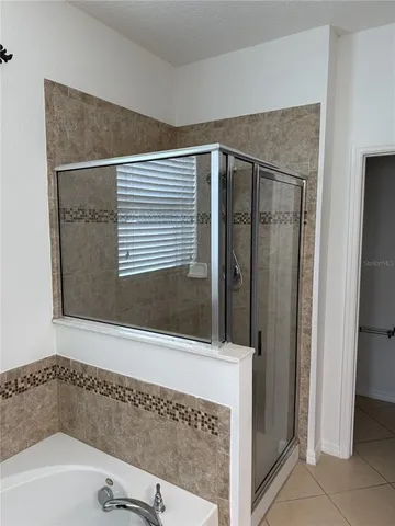 a bathroom with a bathtub and a shower
