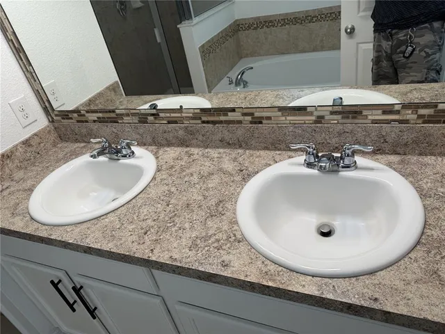 a bathroom with a sink and mirror