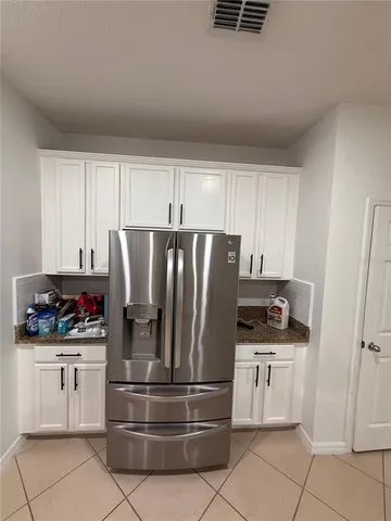 a kitchen with stainless steel appliances and white cabinets