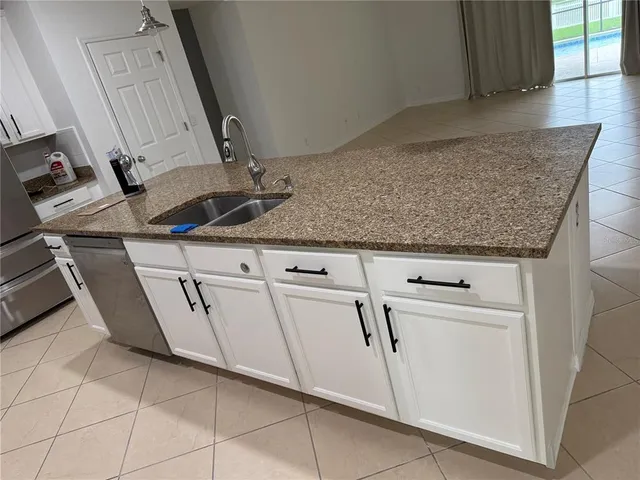 a close view of a sink a washer and dryer