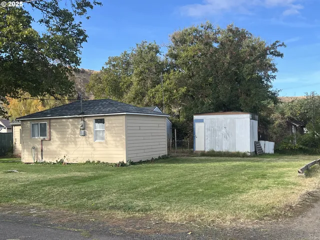 a front view of house with yard and trees