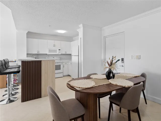 a kitchen with a table and chairs in it