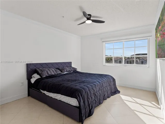 a bedroom with a large bed and a window