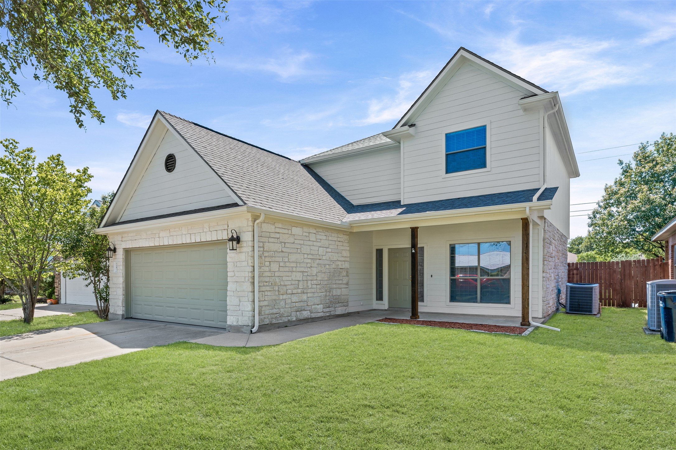 243 Engineers Pass Jarrell, TX 76537 - Photo 2 of 40 Contemporary two-story exterior featuring white siding and stone accents