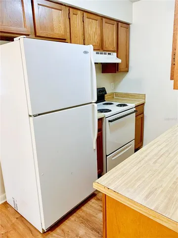 a white refrigerator freezer sitting inside of a kitchen