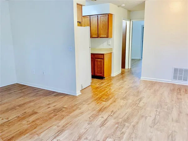 a view of empty room with a fireplace and cabinet