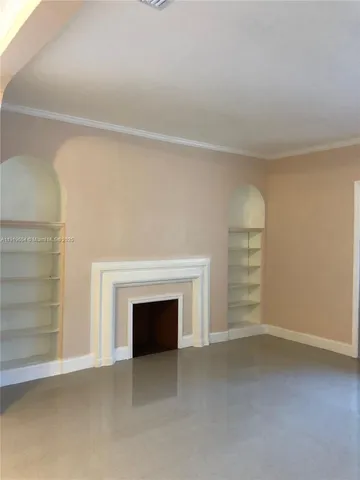a view of empty room with a fireplace