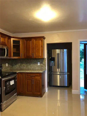 a kitchen with granite countertop cabinets sink and window