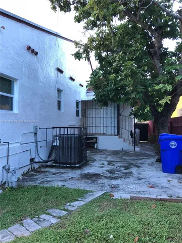 a view of a backyard with a table and chair