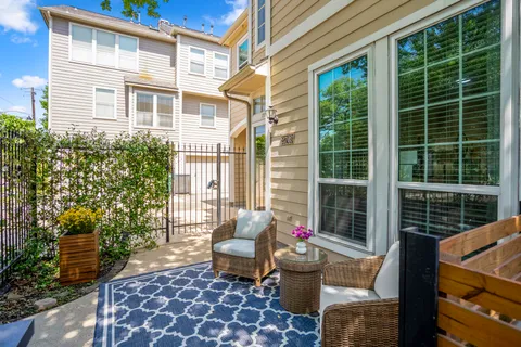 a view of a patio with couches chairs and potted plants