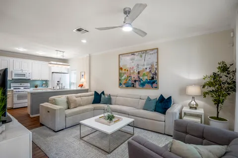 a kitchen with stainless steel appliances granite countertop a sink a stove and refrigerator