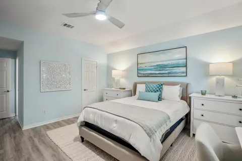 a bathroom with a granite countertop sink a toilet and shower