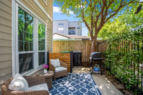 a living room with furniture a flat screen tv and a window