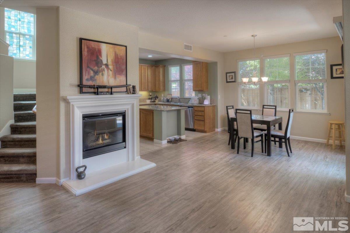 6923 Sacred Circle Sparks, NV 89436 - Photo 1 of 27 a dining room with furniture and wooden floor