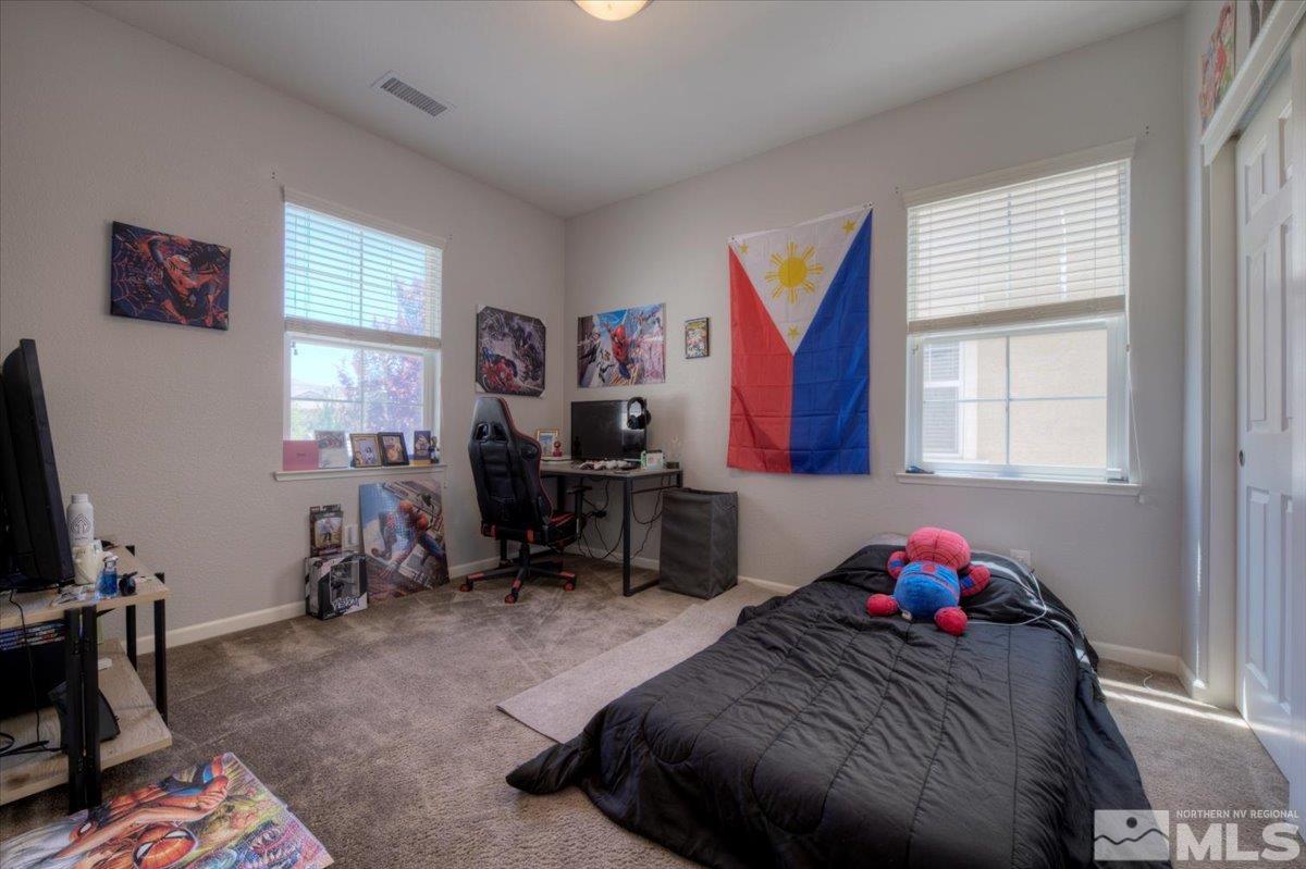 6923 Sacred Circle Sparks, NV 89436 - Photo 20 of 27 a bedroom with bed and a window