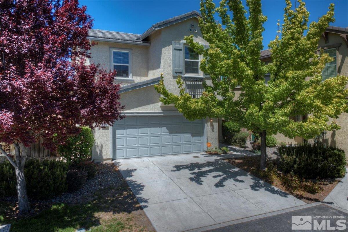 6923 Sacred Circle Sparks, NV 89436 - Photo 2 of 27 a front view of a house with garden