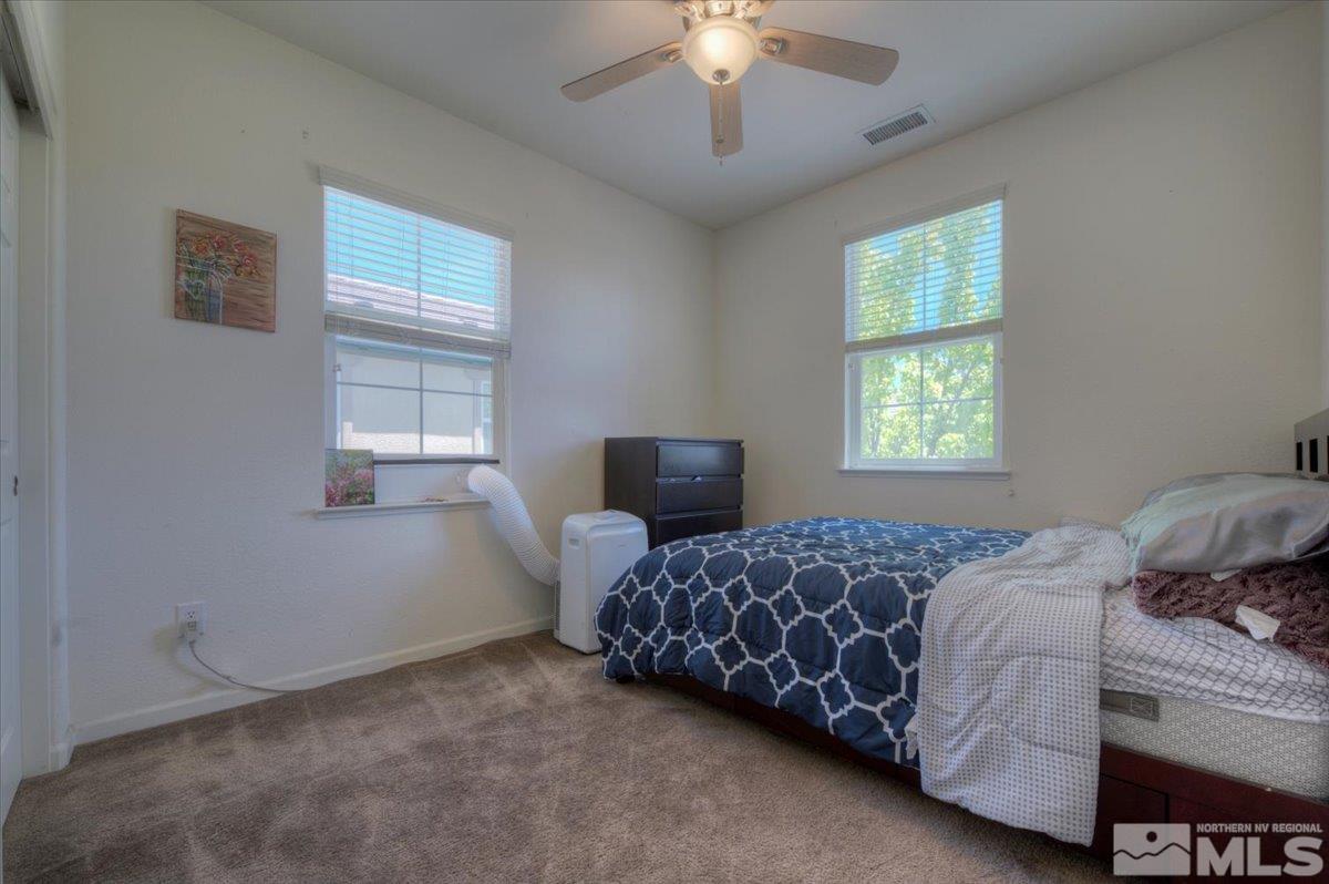 6923 Sacred Circle Sparks, NV 89436 - Photo 21 of 27 a bedroom with a bed and a window