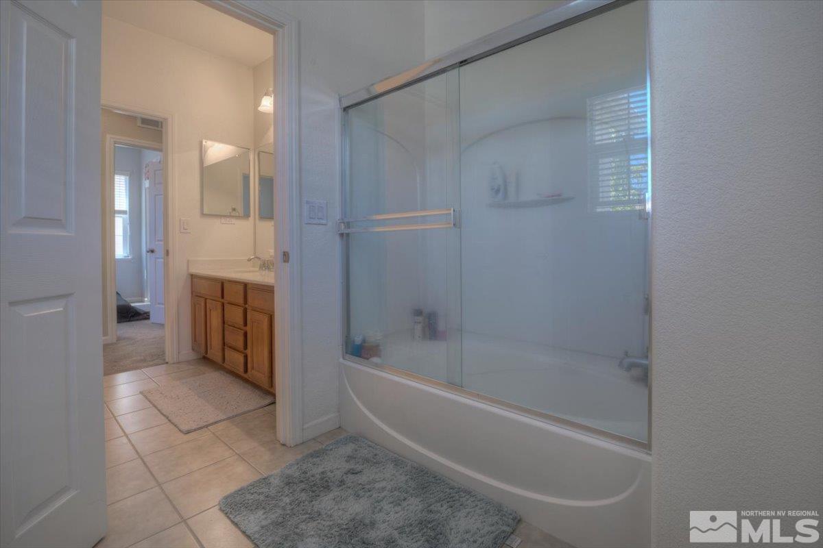 6923 Sacred Circle Sparks, NV 89436 - Photo 23 of 27 a bathroom with a bathtub and a shower