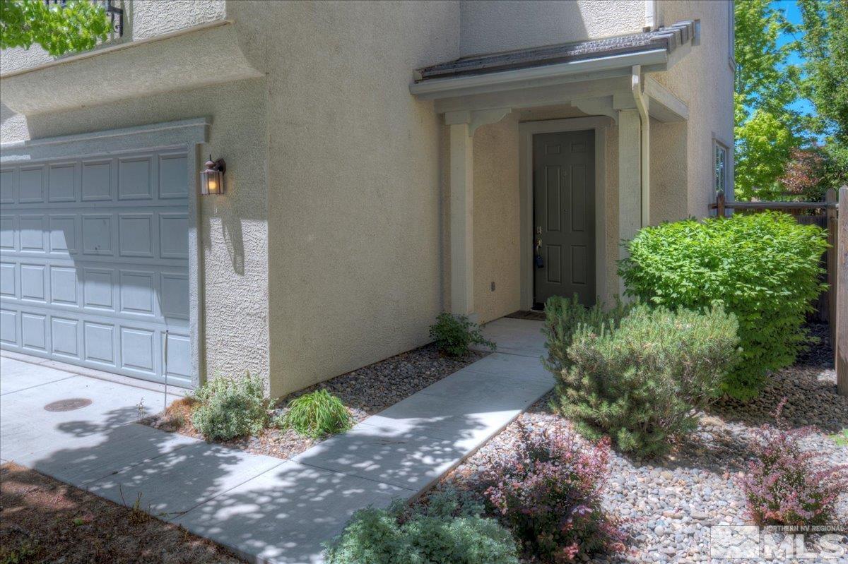 6923 Sacred Circle Sparks, NV 89436 - Photo 3 of 27 a view of a house with a yard and plants