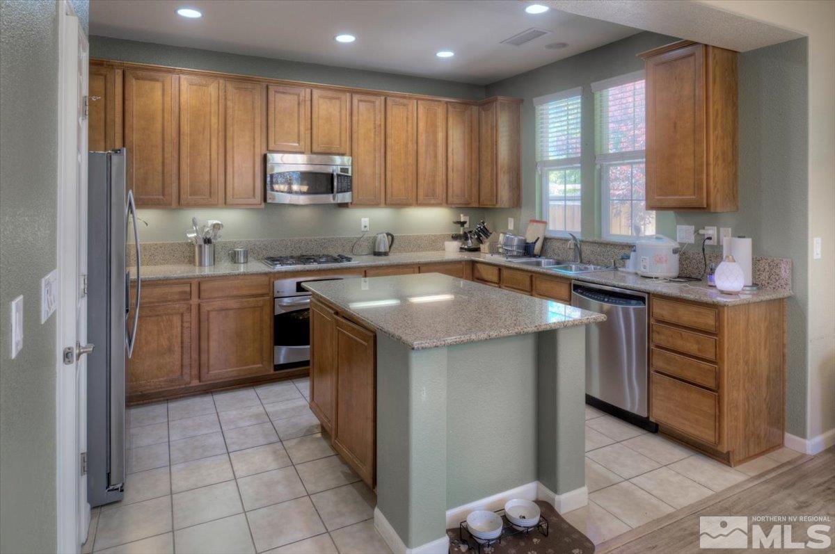 6923 Sacred Circle Sparks, NV 89436 - Photo 4 of 27 a kitchen with a sink stove top oven and cabinets