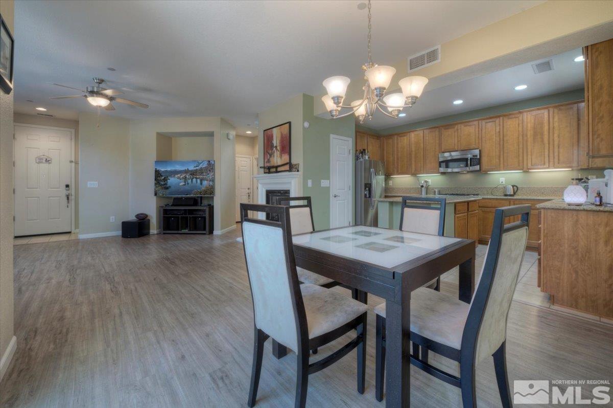 6923 Sacred Circle Sparks, NV 89436 - Photo 7 of 27 a view of a dining room with furniture and wooden floor