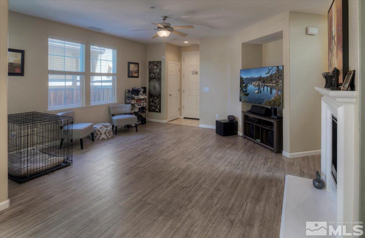 6923 Sacred Circle Sparks, NV 89436 - Photo 9 of 27 a living room with furniture and a flat screen tv