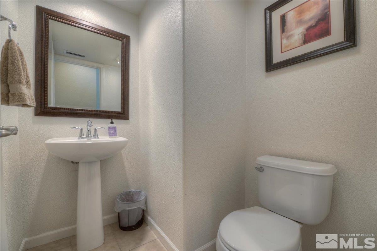 6923 Sacred Circle Sparks, NV 89436 - Photo 10 of 27 a bathroom with a toilet sink and mirror