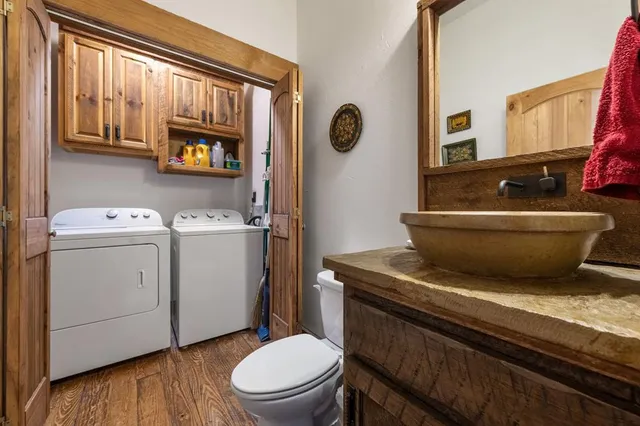 a bathroom with a granite countertop toilet sink and mirror