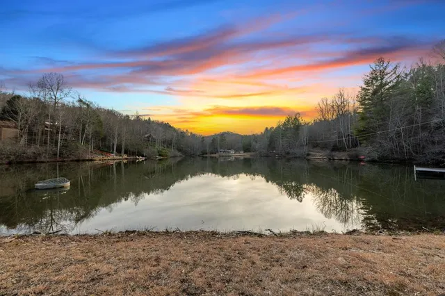 a pathway of a house with yard and trees in the background