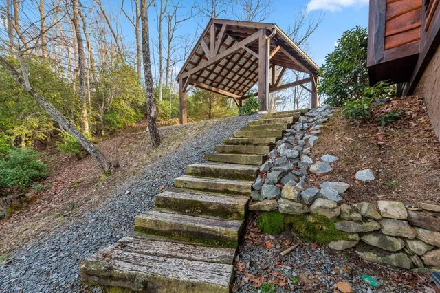 a view of a house with a large window and potted plants