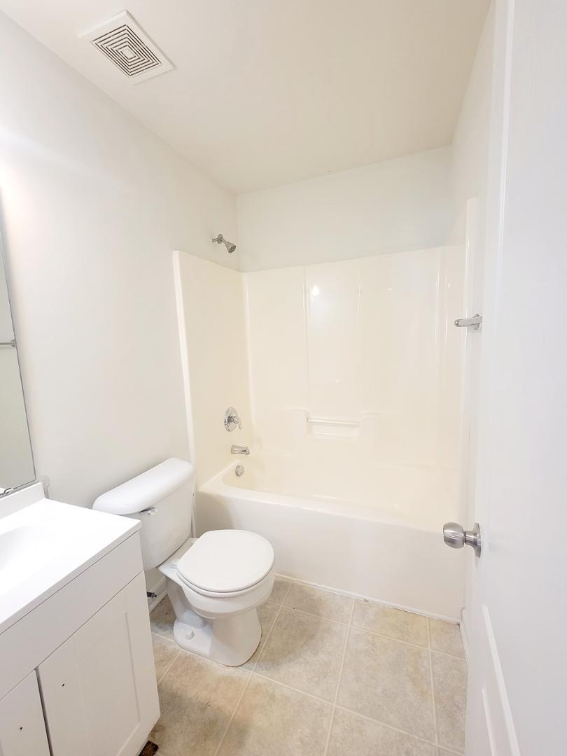 5423 Big Bass Drive Raleigh, NC 27610 - Photo 17 of 42 a bathroom with a toilet a sink and a bathtub