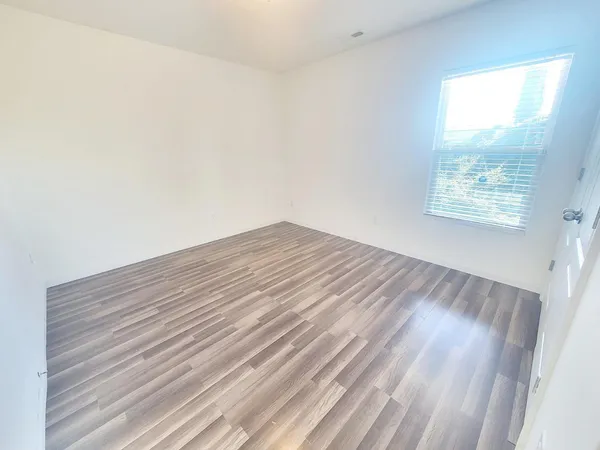 a view of wooden floor and windows in a room