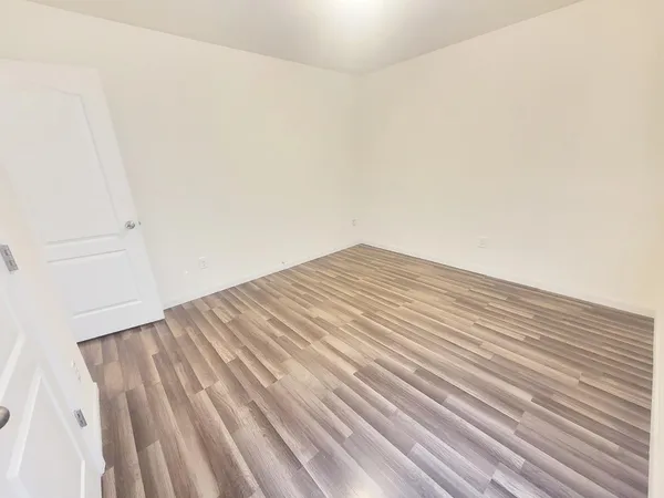 a view of wooden floor and brick wall