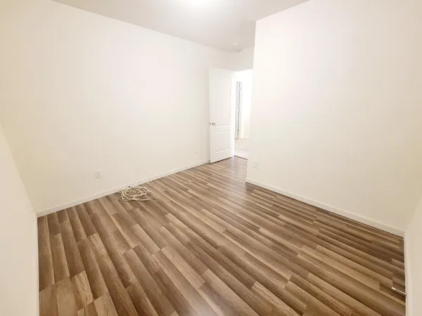 a view of a room with wooden floor