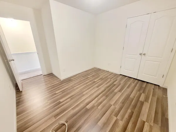 a view of a room with wooden floor and staircase