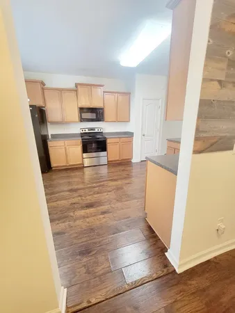 a view of a kitchen with wooden floor