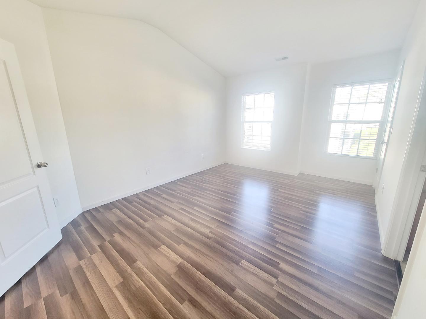 5423 Big Bass Drive Raleigh, NC 27610 - Photo 36 of 42 an empty room with wooden floor and windows