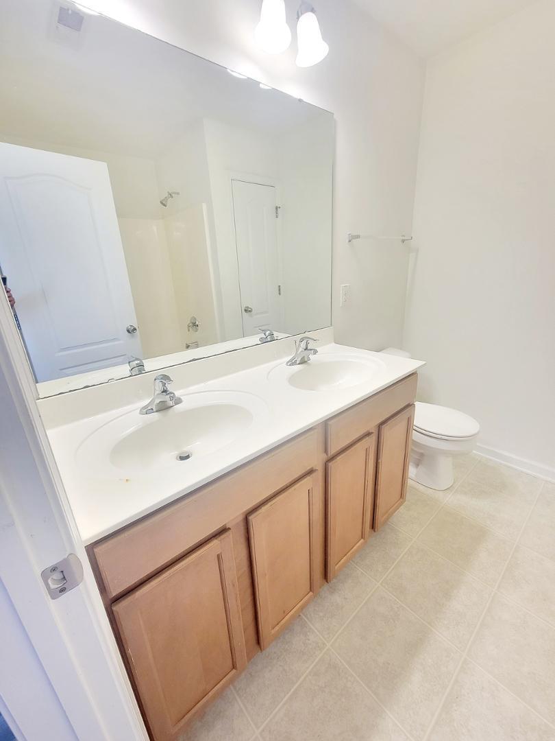 5423 Big Bass Drive Raleigh, NC 27610 - Photo 39 of 42 a bathroom with a sink a toilet and mirror