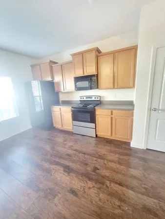 a kitchen with granite countertop a stove and a sink